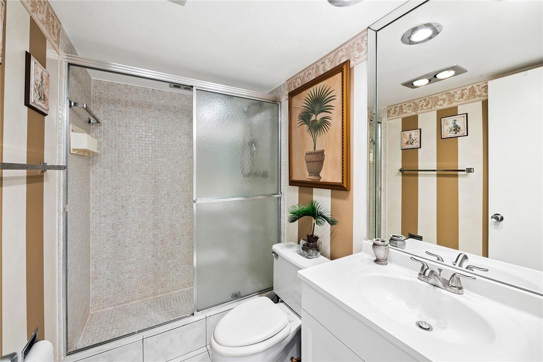 2661 South Course Drive, Unit 209 Pompano Beach, FL 33069 - Photo 15 of 21 a bathroom with a sink toilet and shower