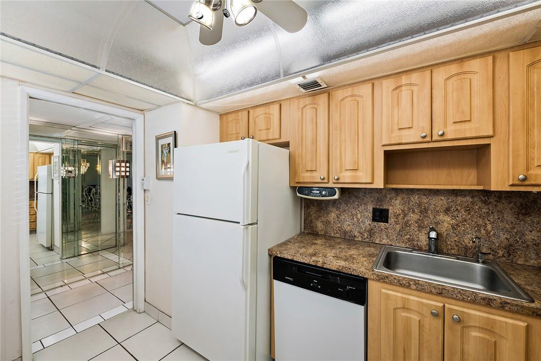 2661 South Course Drive, Unit 209 Pompano Beach, FL 33069 - Photo 3 of 21 a white refrigerator freezer sitting inside of a kitchen
