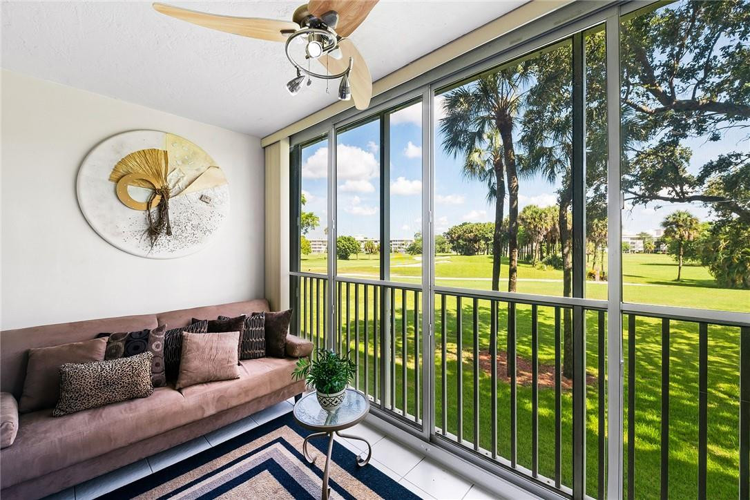2661 South Course Drive, Unit 209 Pompano Beach, FL 33069 - Photo 6 of 21 a living room with large windows