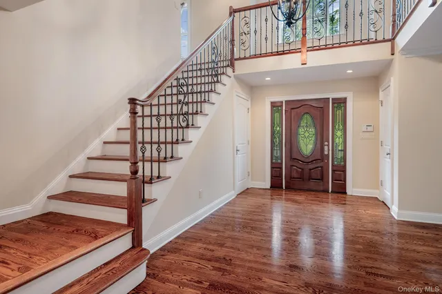 a view of entryway and hall with wooden floor