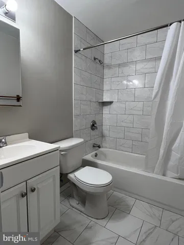 a bathroom with a toilet sink and shower