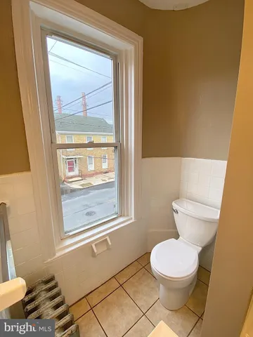 a bathroom with a toilet a sink and a window