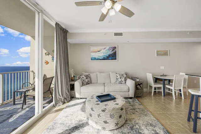 a living room with furniture and a dining table with wooden floor