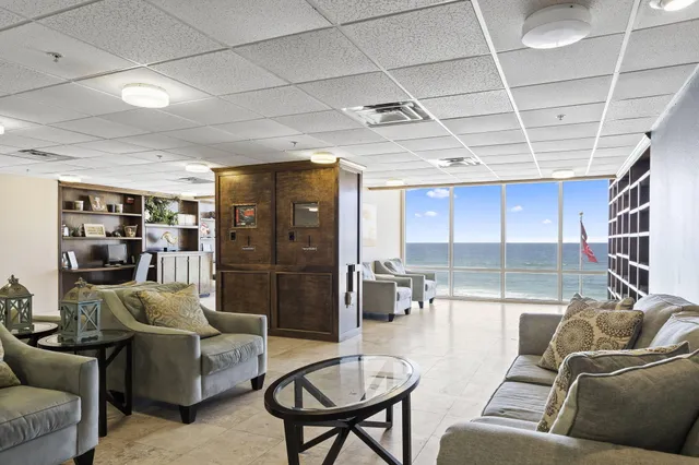 a living room with furniture and a glass door shower