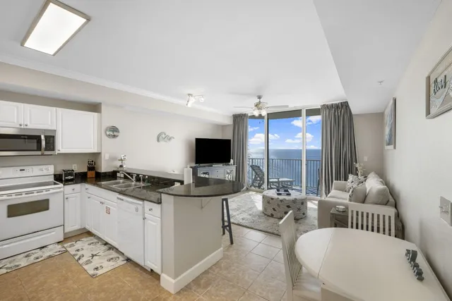 a kitchen with stainless steel appliances kitchen island granite countertop a sink and a stove