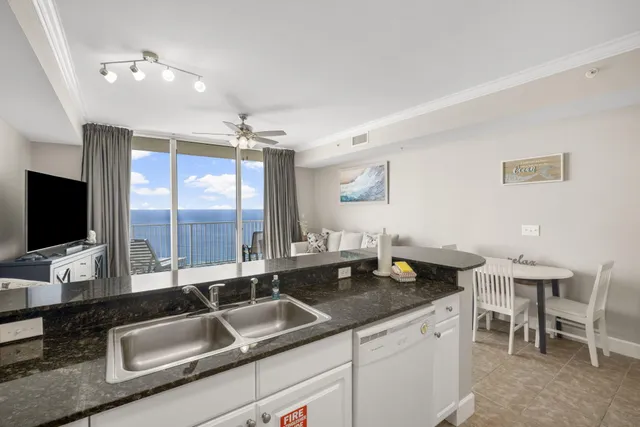 a kitchen with a sink and a large window