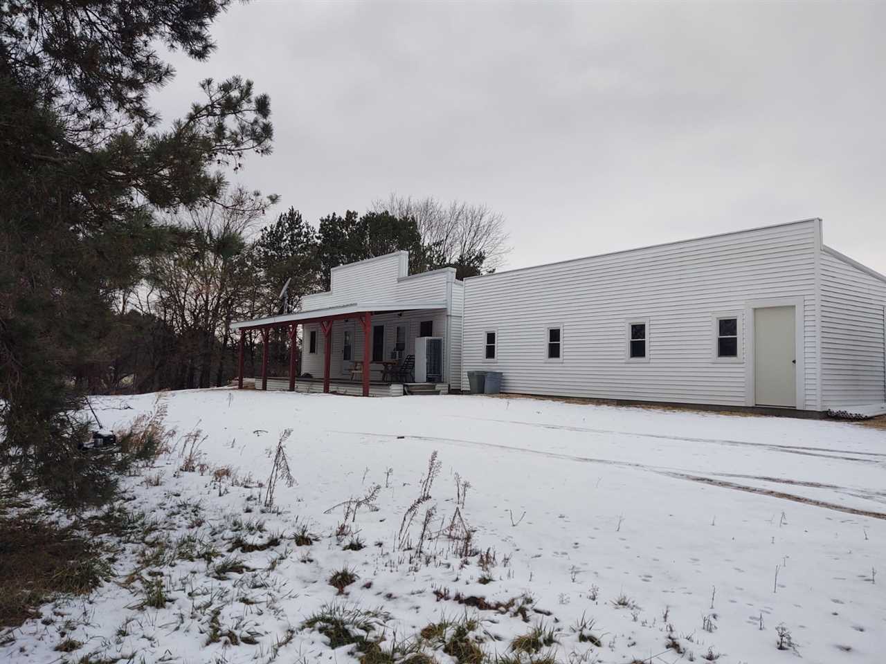 12455 Fish Hatchery Road Pecatonica, IL 61063 - Photo 3 of 32 a front view of a house with a yard covered in snow