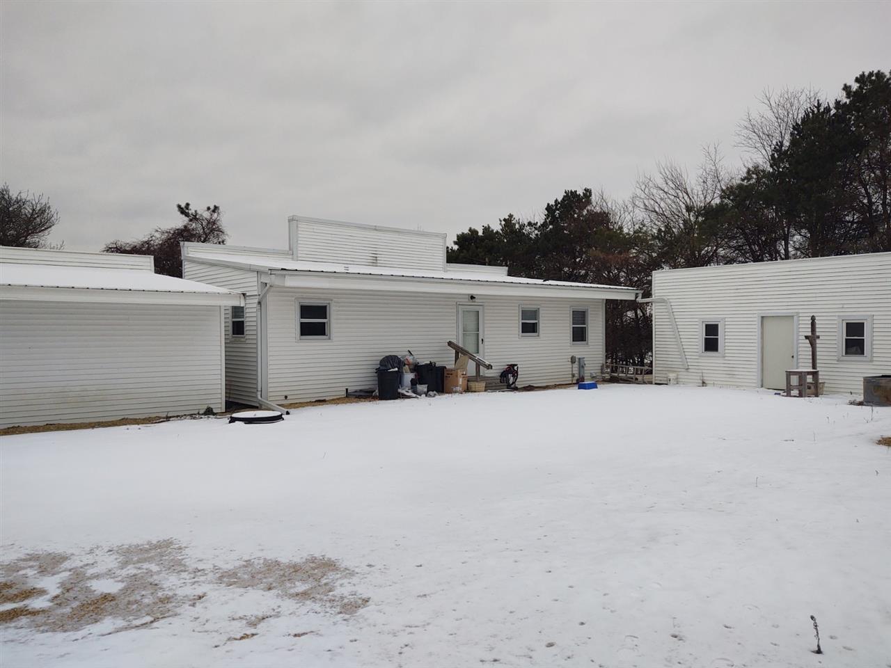 12455 Fish Hatchery Road Pecatonica, IL 61063 - Photo 7 of 32 a view of a white house with a snow on the road