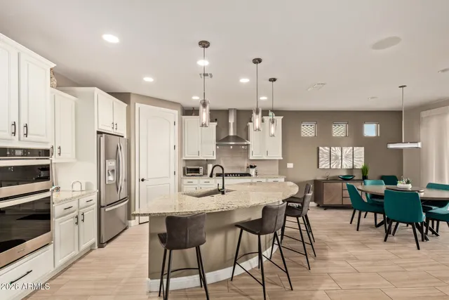 a large kitchen with a table and chairs