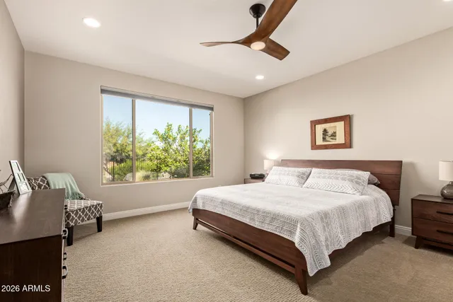 a bed sitting in a bedroom next to a window