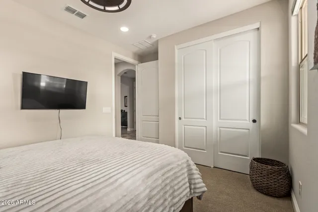 a bedroom with a bed and a flat screen tv