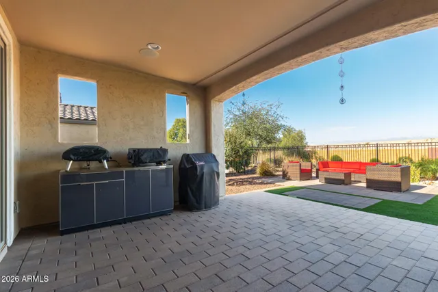 a kitchen with stainless steel appliances kitchen island granite countertop a refrigerator and a stove
