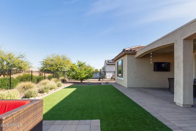 a view of a house with backyard sitting area and garden