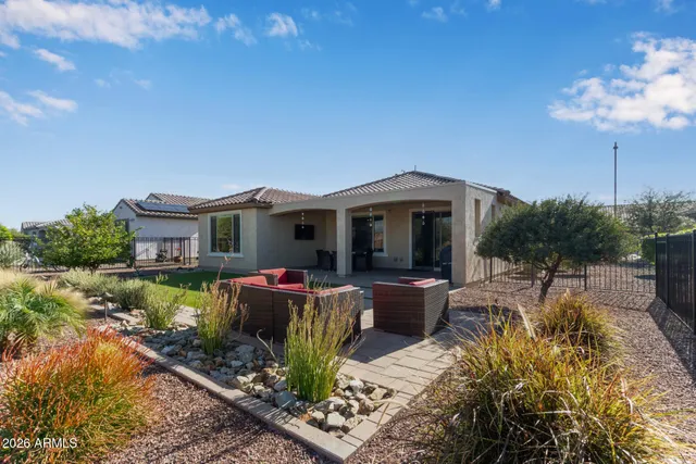 a view of a house with a yard and pathway