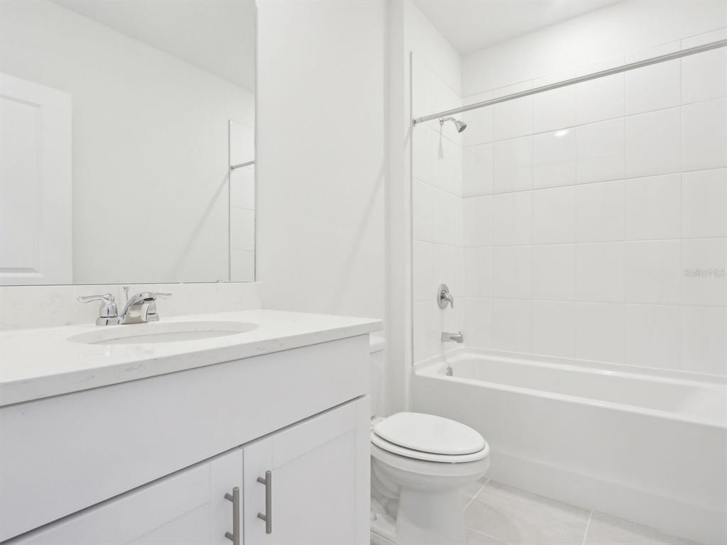 1643 Bark Rdg Drive Auburndale, FL 33823 - Photo 17 of 31 a bathroom with a sink a toilet and shower