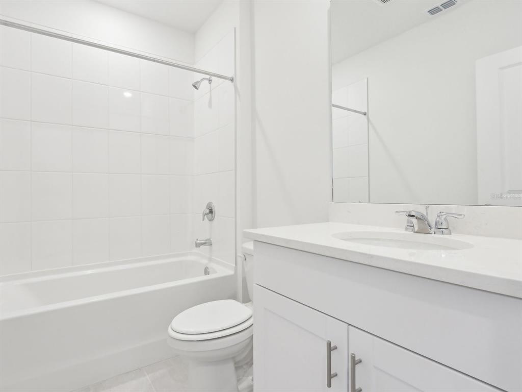 1643 Bark Rdg Drive Auburndale, FL 33823 - Photo 20 of 31 a bathroom with a sink a toilet and a bathtub
