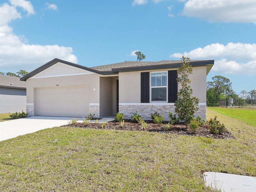 1643 Bark Rdg Drive Auburndale, FL 33823 - Photo 2 of 31 a front view of a house with garden