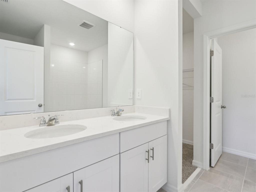 1643 Bark Rdg Drive Auburndale, FL 33823 - Photo 27 of 31 a bathroom with a sink and a mirror