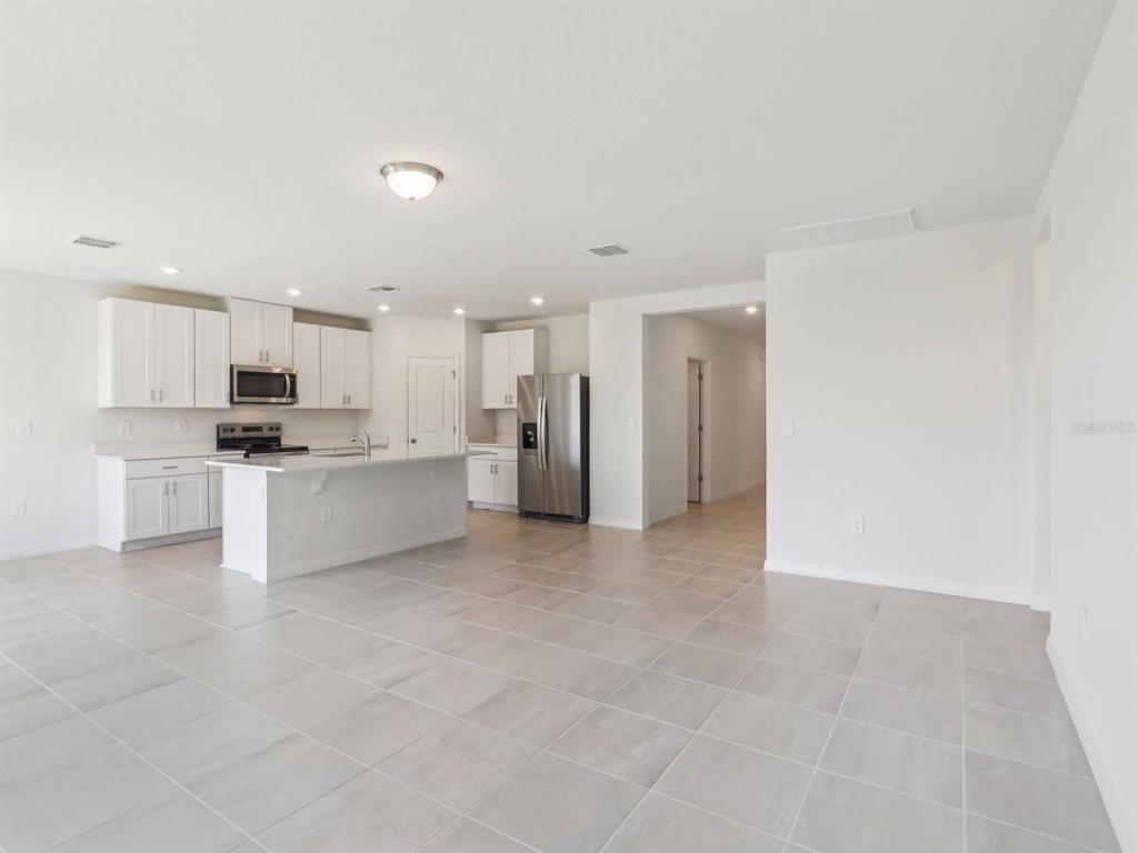 1643 Bark Rdg Drive Auburndale, FL 33823 - Photo 5 of 31 a view of a kitchen with a sink and a refrigerator