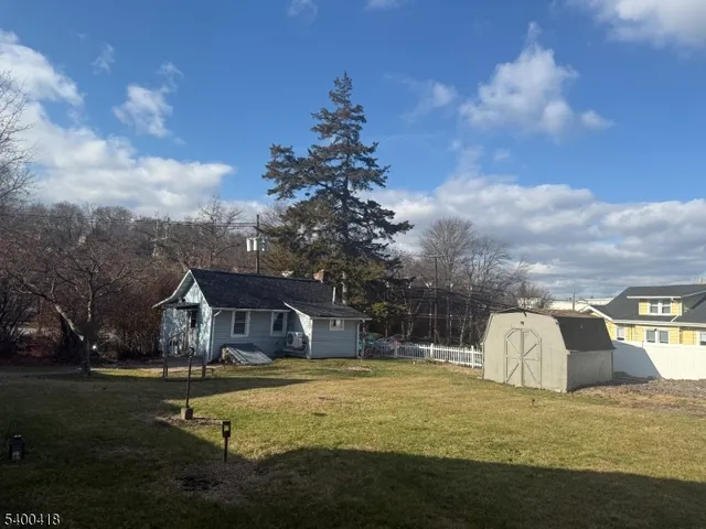 a house view with swimming pool and trees in the background