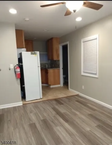 a view of a kitchen with a sink and a refrigerator