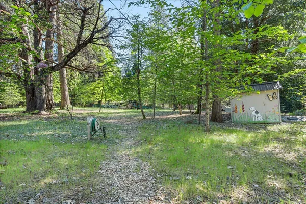a view of a house with backyard sitting area and garden
