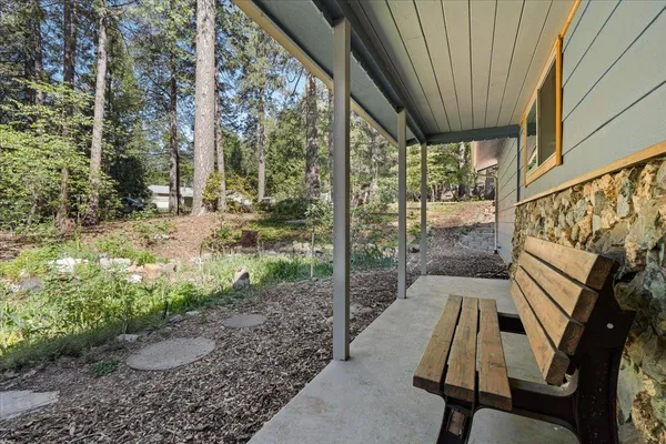 a room with stainless steel appliances dining table and chairs