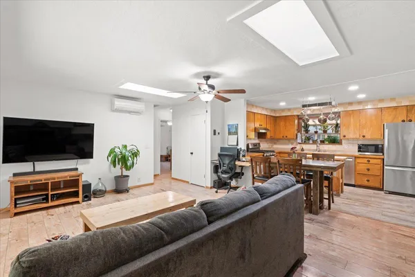 a kitchen with a refrigerator a stove a sink dishwasher with a dining table and chairs