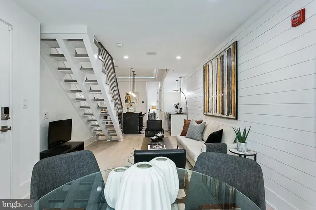 a living room with furniture a fireplace and a potted plant