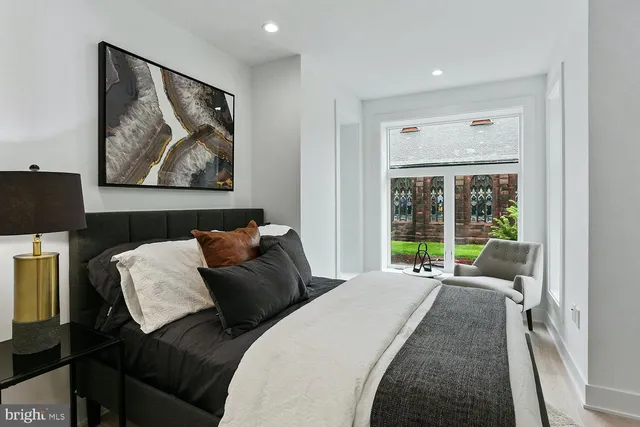 a bed room with a bed and a painting on the wall