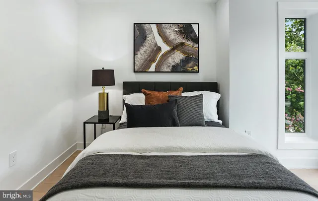 a large bed sitting in a bedroom next to a window