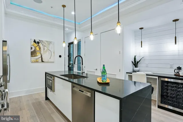 a kitchen with sink a counter and cabinets