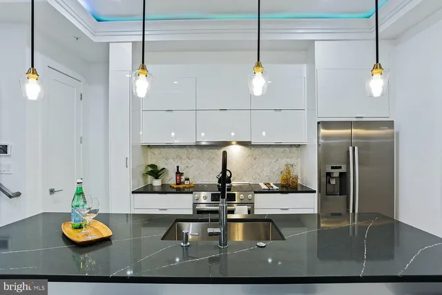 a kitchen with sink and refrigerator