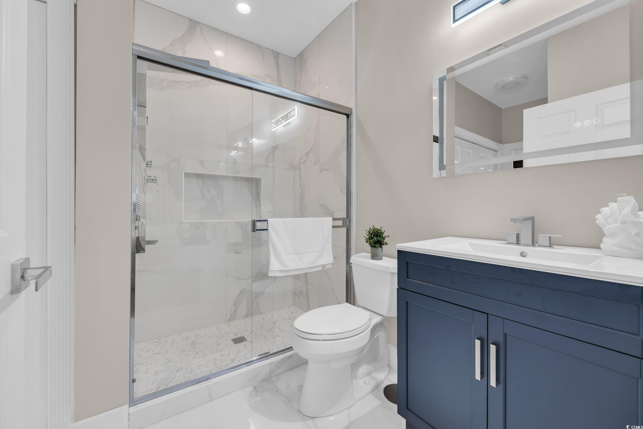 4821 Luster Leaf Circle, Unit 101 Myrtle Beach, SC 29577 - Photo 12 of 30 Bathroom with vanity, a marble finish shower, marble finish flooring, and recessed lighting