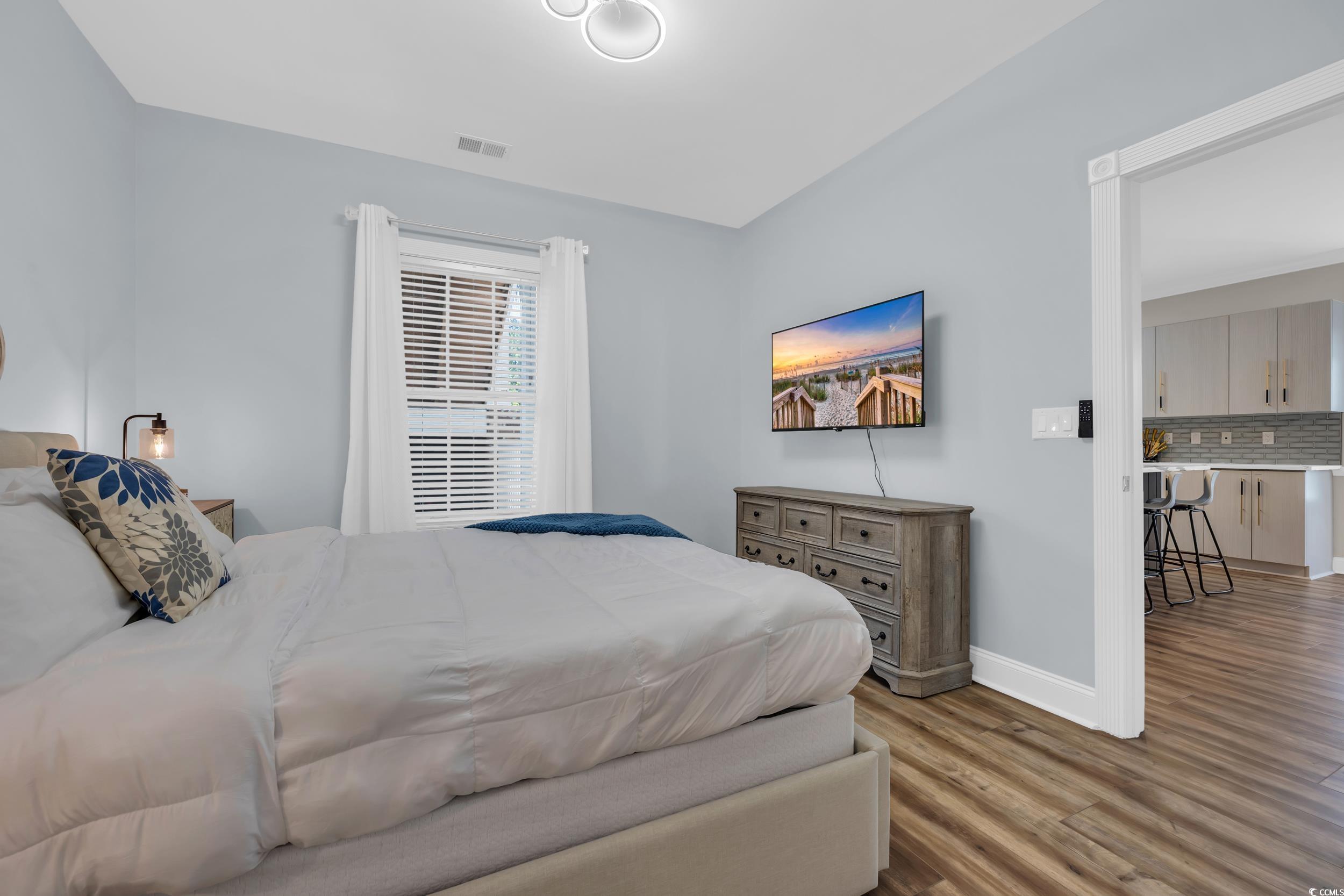 4821 Luster Leaf Circle, Unit 101 Myrtle Beach, SC 29577 - Photo 13 of 30 Bedroom featuring wood finished floors and baseboards