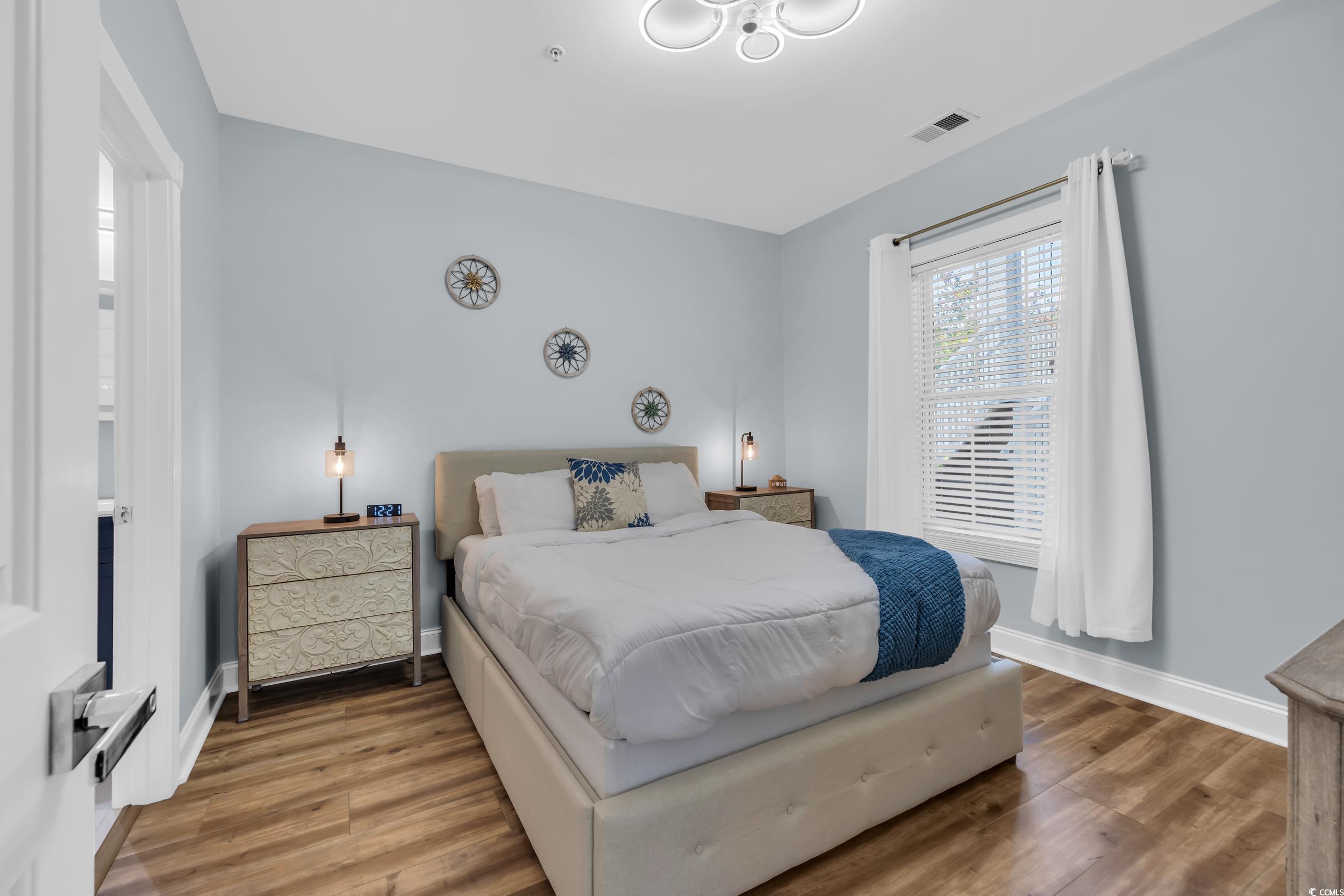 4821 Luster Leaf Circle, Unit 101 Myrtle Beach, SC 29577 - Photo 14 of 30 Bedroom featuring wood finished floors and baseboards