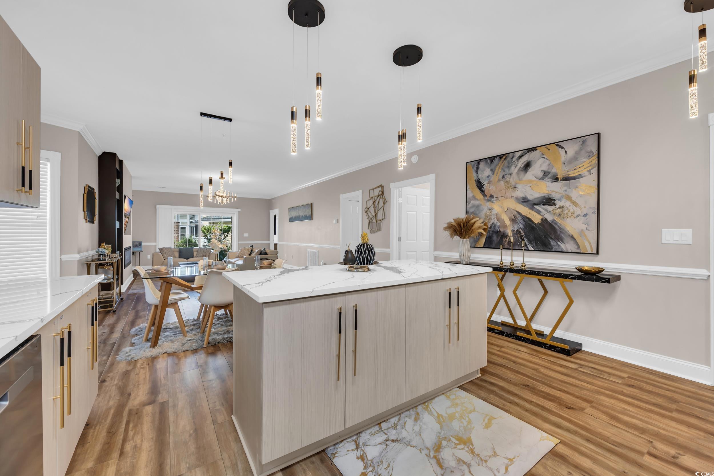 4821 Luster Leaf Circle, Unit 101 Myrtle Beach, SC 29577 - Photo 16 of 30 Kitchen with light brown cabinetry, hanging light fixtures, light stone countertops, and crown molding