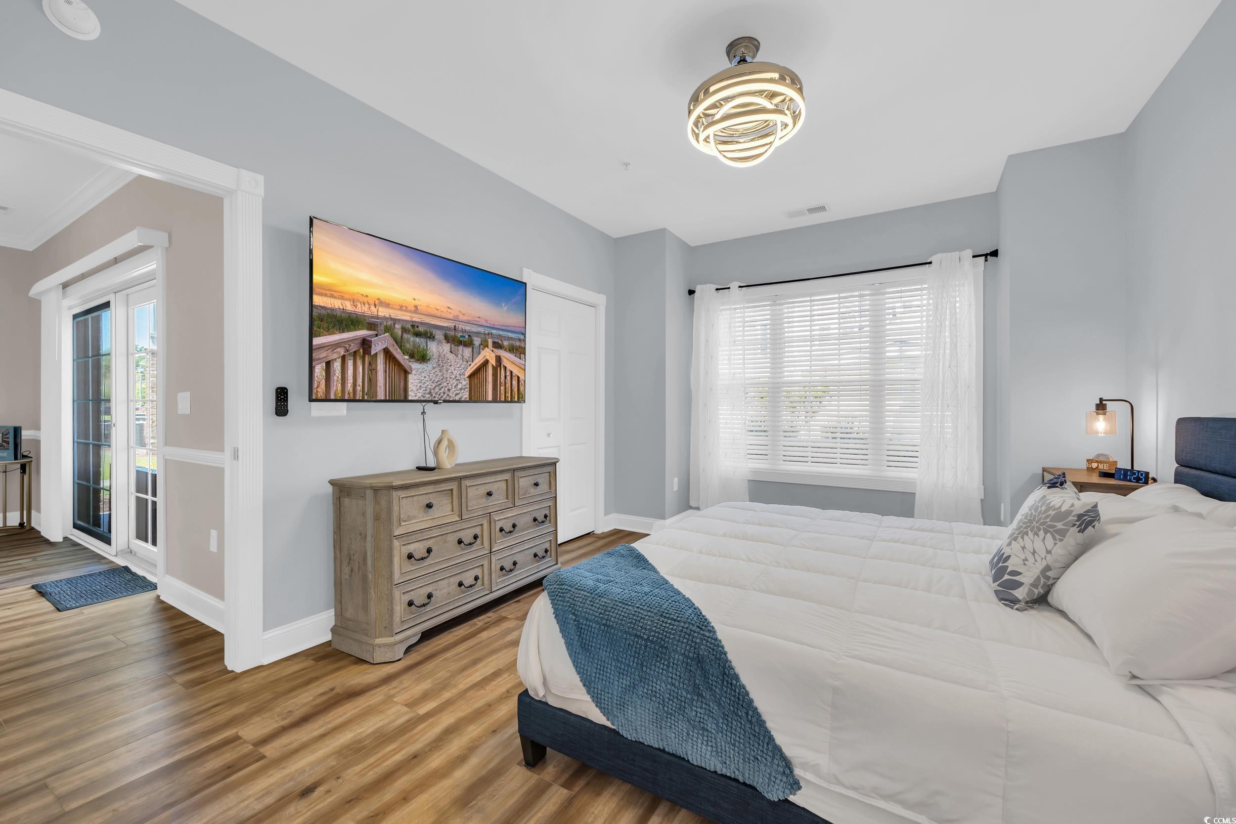 4821 Luster Leaf Circle, Unit 101 Myrtle Beach, SC 29577 - Photo 3 of 30 Bedroom with wood finished floors and access to outside