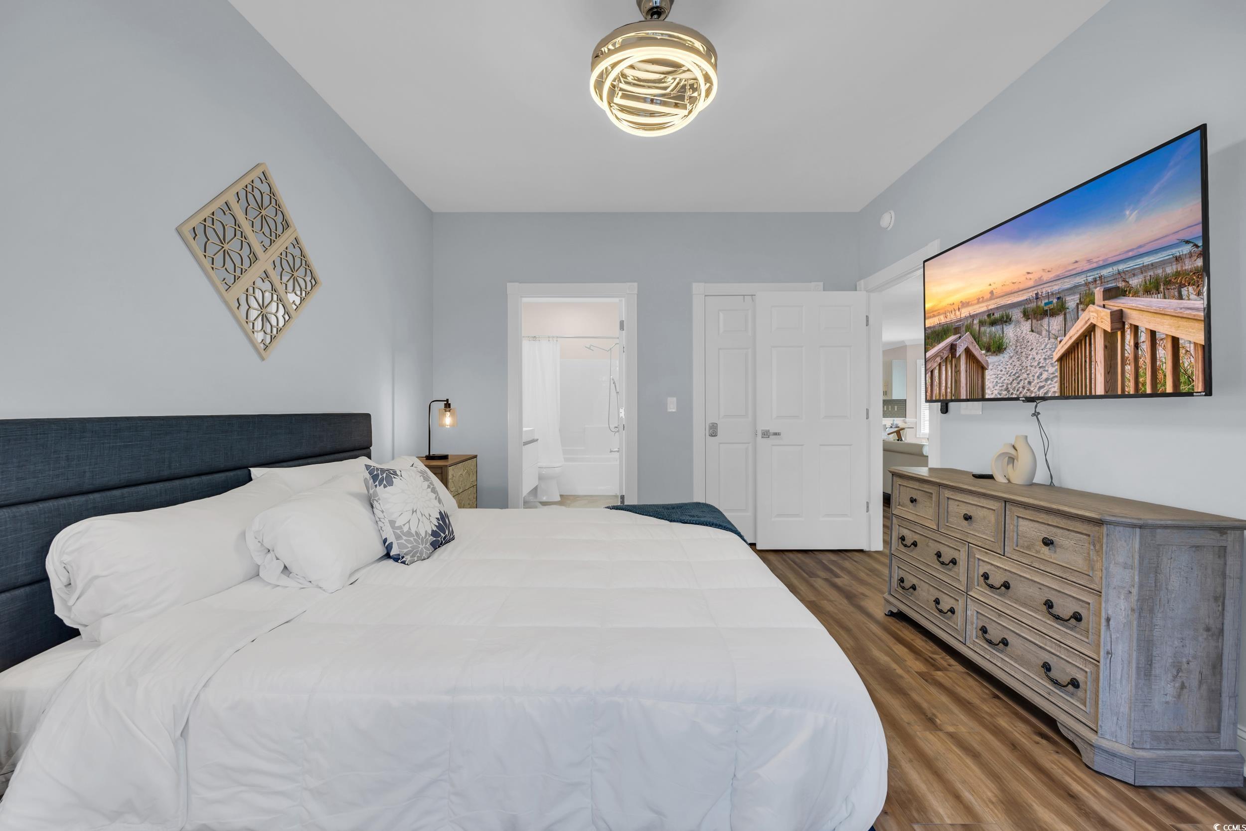 4821 Luster Leaf Circle, Unit 101 Myrtle Beach, SC 29577 - Photo 4 of 30 Bedroom with dark wood-style flooring and ensuite bathroom