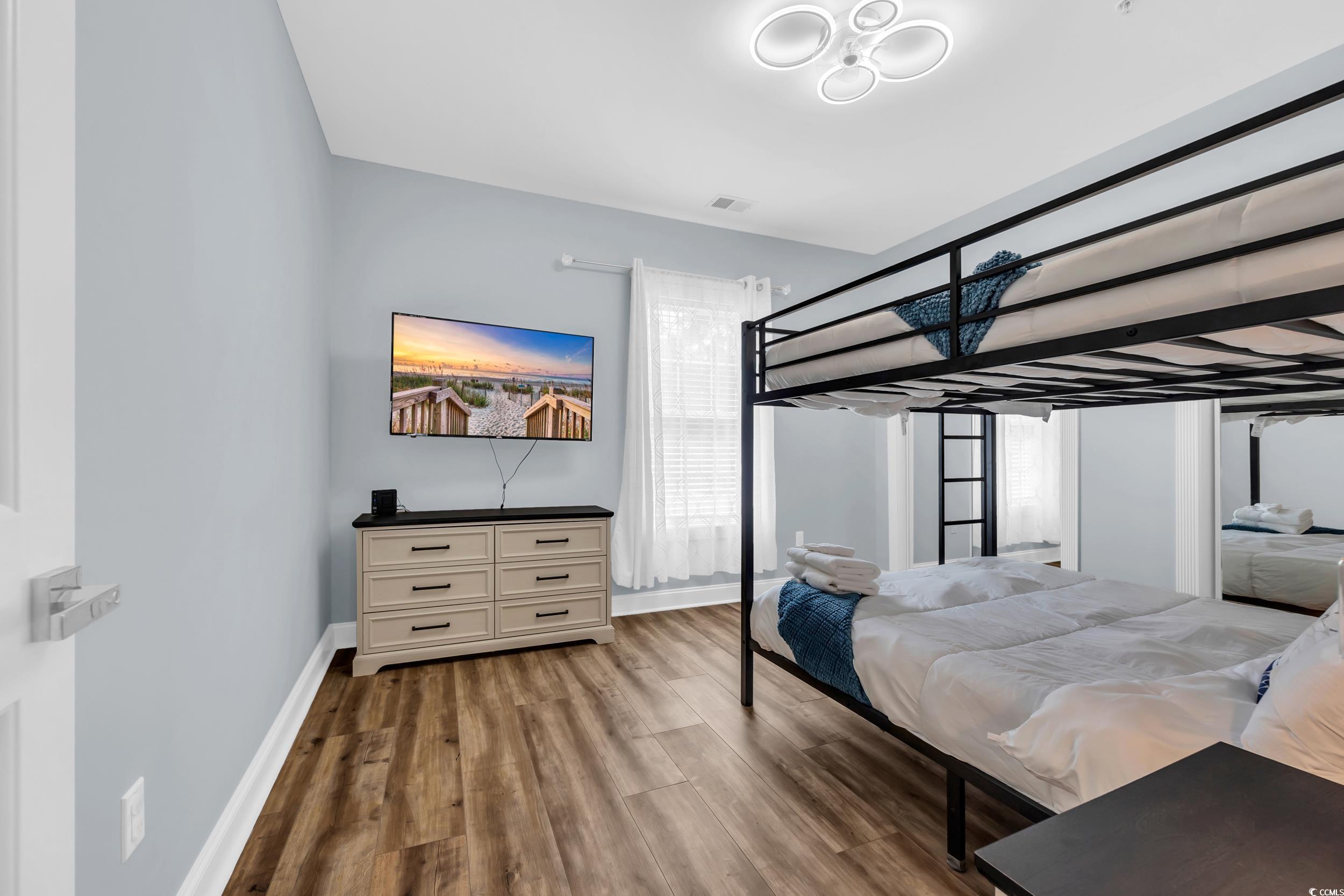 4821 Luster Leaf Circle, Unit 101 Myrtle Beach, SC 29577 - Photo 6 of 30 Bedroom with wood finished floors and baseboards