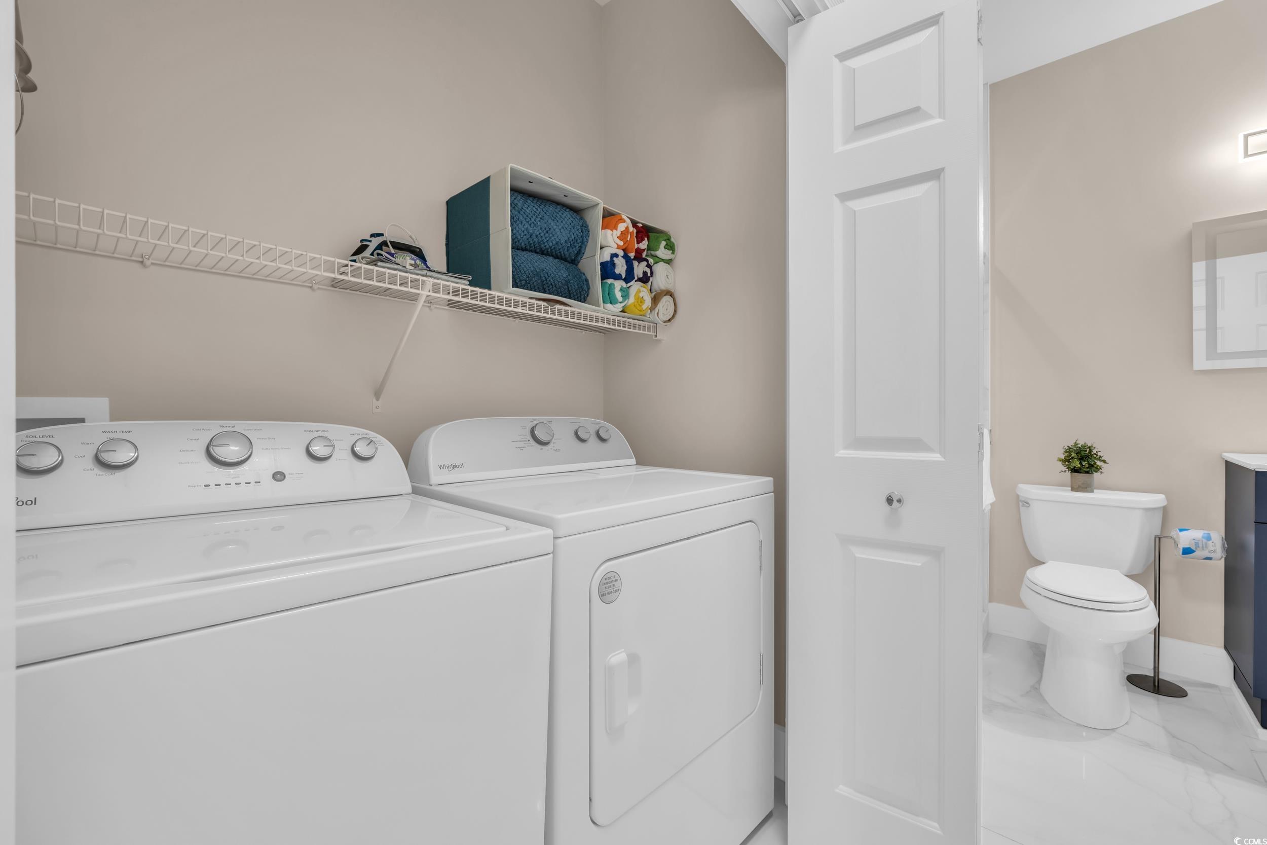 4821 Luster Leaf Circle, Unit 101 Myrtle Beach, SC 29577 - Photo 8 of 30 Washroom featuring independent washer and dryer and marble look tile flooring