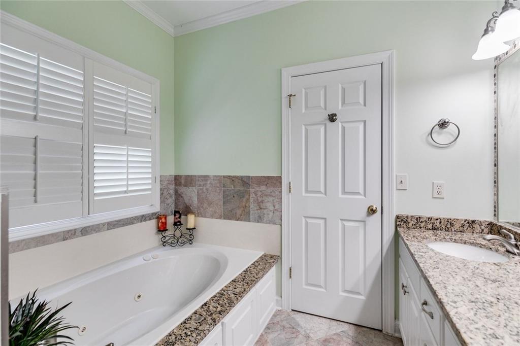 110 Pond View Point LaGrange, GA 30240 - Photo 30 of 68 a bathroom with a granite countertop tub sink and mirror