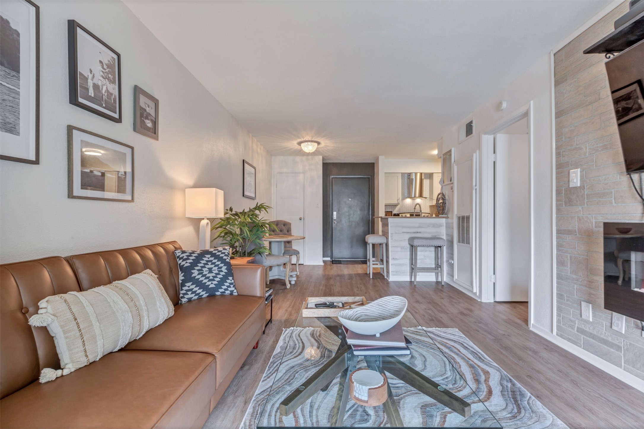 13151 Walden Road, Unit 142 Montgomery, TX 77356 - Photo 16 of 50 a living room with furniture and a wooden floor