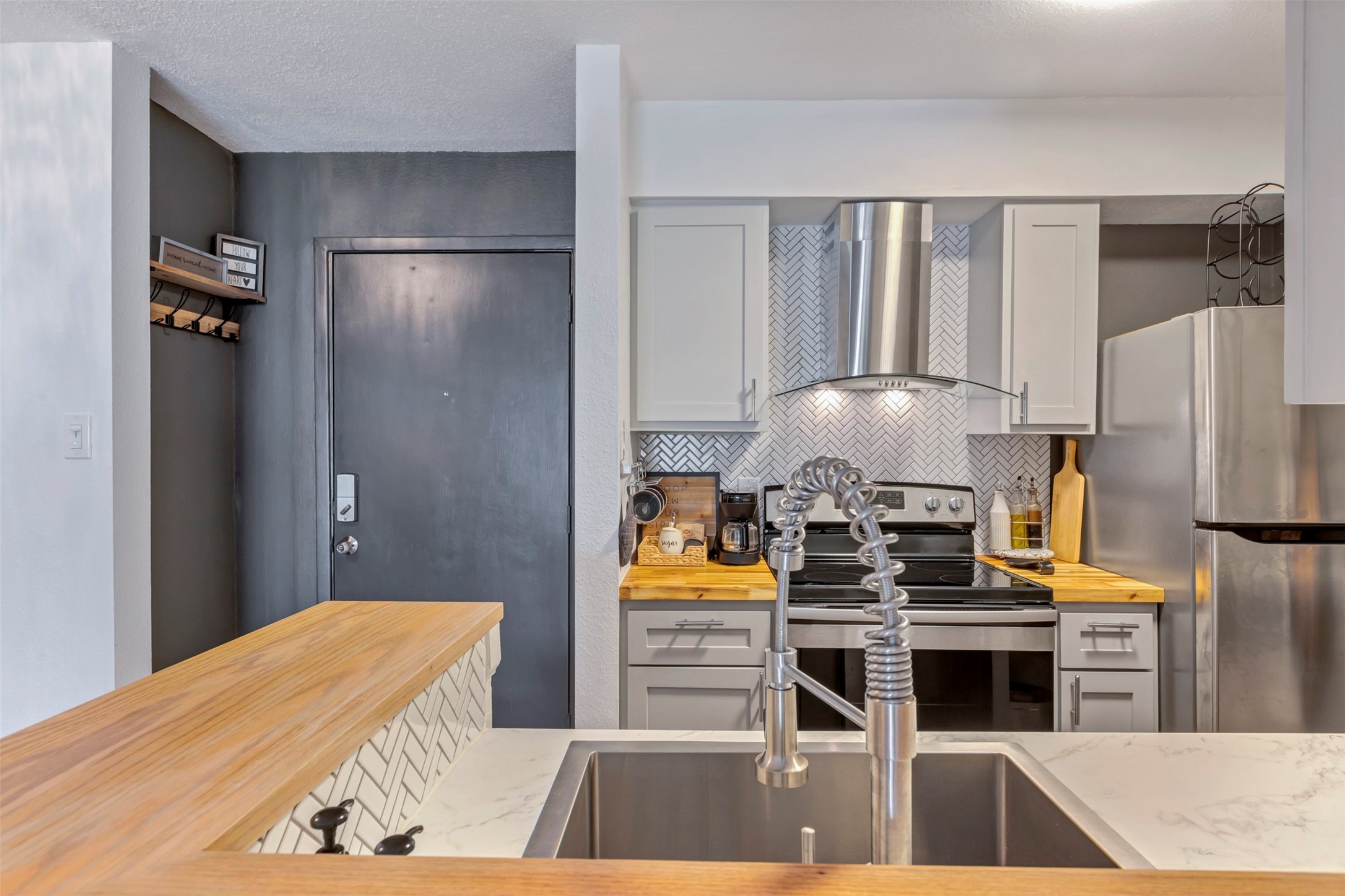 13151 Walden Road, Unit 142 Montgomery, TX 77356 - Photo 18 of 50 a kitchen with stainless steel appliances granite countertop a refrigerator and a stove