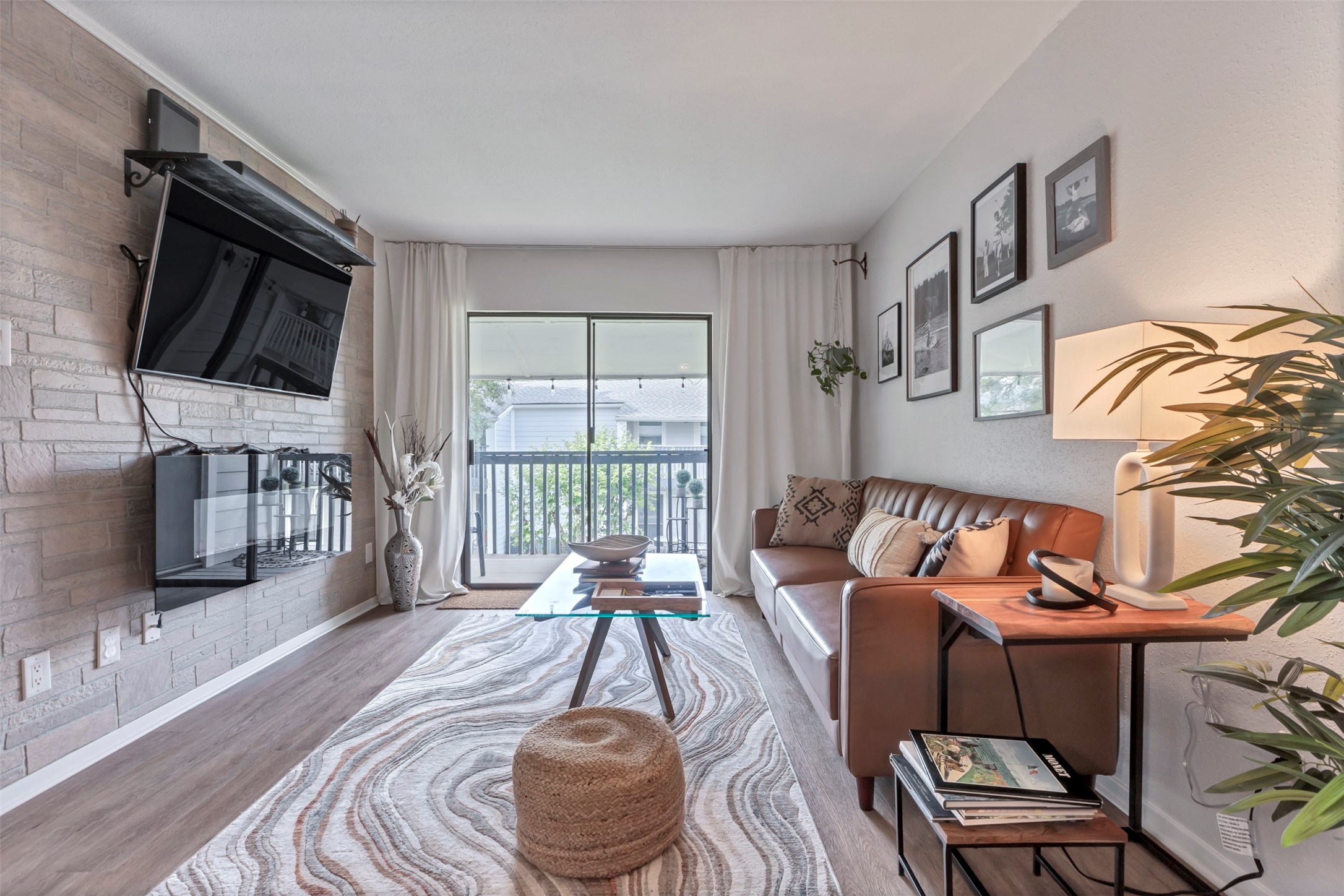 13151 Walden Road, Unit 142 Montgomery, TX 77356 - Photo 2 of 50 a living room with furniture and a flat screen tv