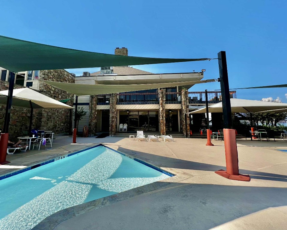 13151 Walden Road, Unit 142 Montgomery, TX 77356 - Photo 34 of 50 a view of a backyard patio and swimming pool