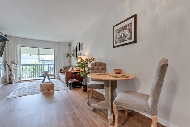 a living room with furniture a table and a large window