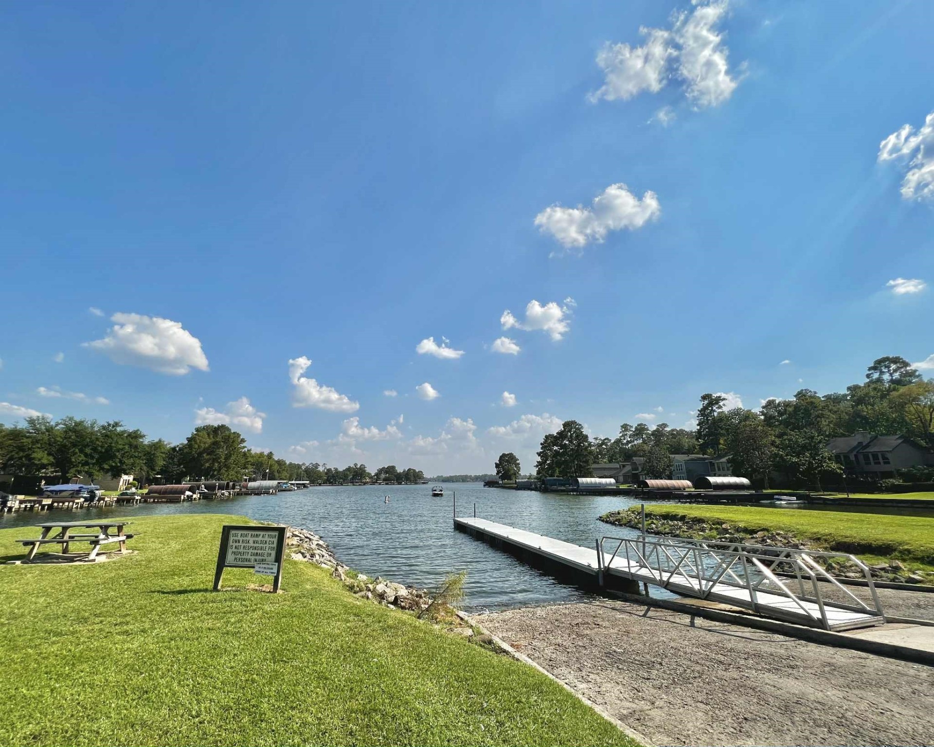 13151 Walden Road, Unit 142 Montgomery, TX 77356 - Photo 44 of 50 a view of a lake with a yard