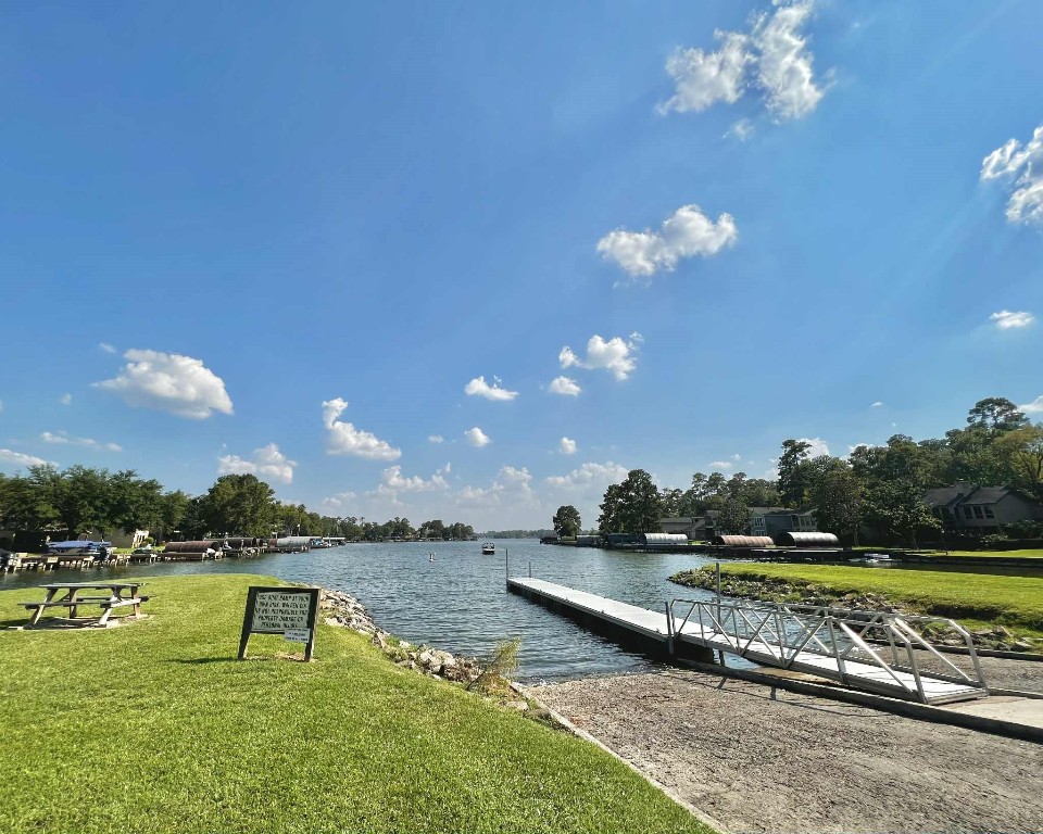 13151 Walden Road, Unit 142 Montgomery, TX 77356 - Photo 44 of 50 a view of a lake with a yard