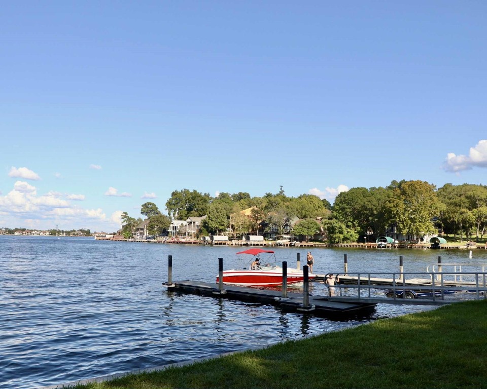 13151 Walden Road, Unit 142 Montgomery, TX 77356 - Photo 45 of 50 a view of a lake with houses in the back
